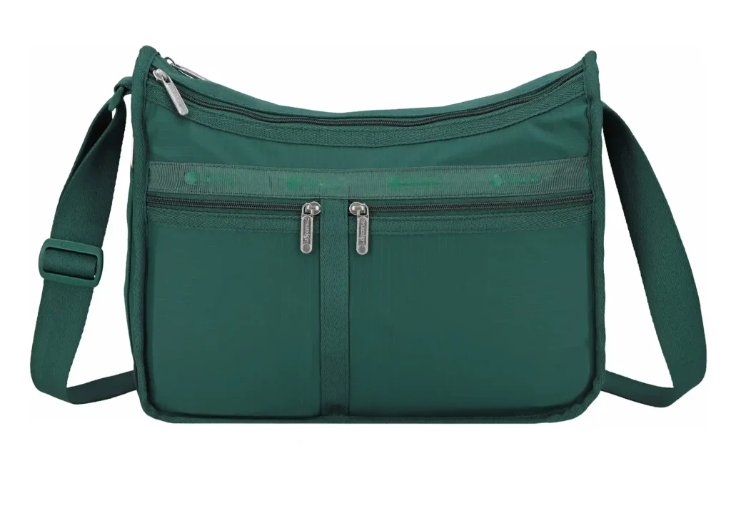 Dark green crossbody bag with a wide adjustable shoulder strap and a curved zippered top. The front has two large side by side zippered pockets with silver zipper pulls.